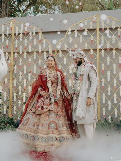 Kunal and Parul sharing a happy moment after their Varmala, surrounded by smoke effects that add a touch of magic.