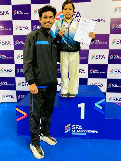 Standing with Kavya on the podium. Her performance at such a young age is a sign of a great future in karate.