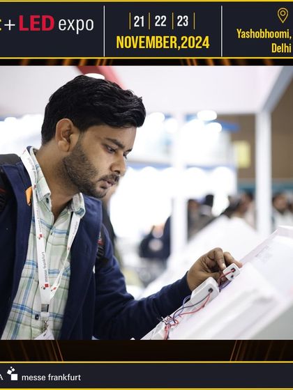 A professional interacts with a new lighting control panel, demonstrating the focus on hands-on experience with the latest technology.