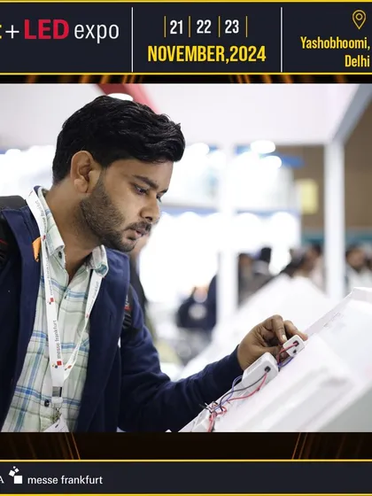 A professional interacts with a new lighting control panel, demonstrating the focus on hands-on experience with the latest technology.