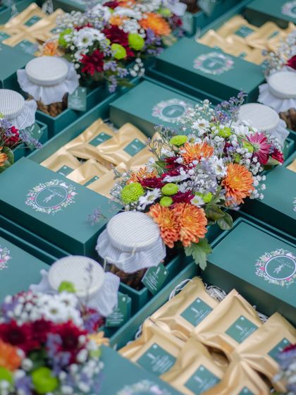 Festive season loading. We create packaging as special as what’s inside, like these elegant teal boxes filled with treats and topped with fresh flowers for a corporate order.