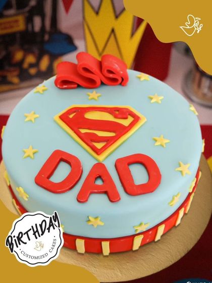 A super cake for a super Dad. This Superman-themed cake is a perfect way to celebrate the hero in your family, complete with his iconic logo and colors.