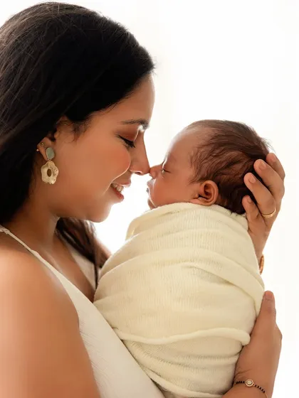 A sweet nose-to-nose moment between a mother and her newborn. These are the simple, intimate gestures that define their bond.