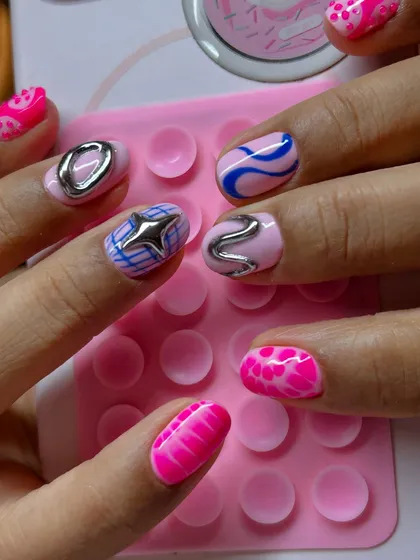 A closer look at the different textures and patterns in this statement nail set, including a 3D star and abstract silver shapes.