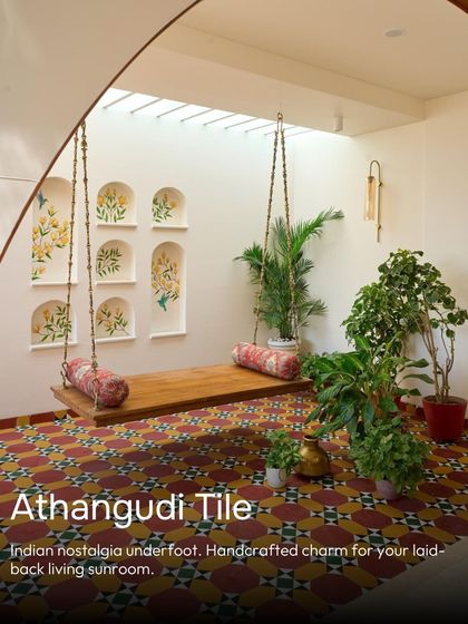 This sunroom is filled with Indian nostalgia. Handcrafted Athangudi tiles provide a colorful, patterned floor underfoot, perfect for a laid-back living space with a traditional swing.