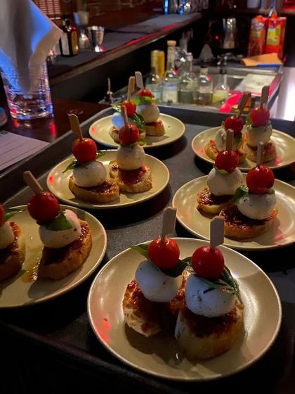 A tray of delectable tomato and cheese pintxos, ready to be served during the Buñol scene. These small bites are packed with flavor, capturing the vibrant and chaotic energy of the Tomatina festival.