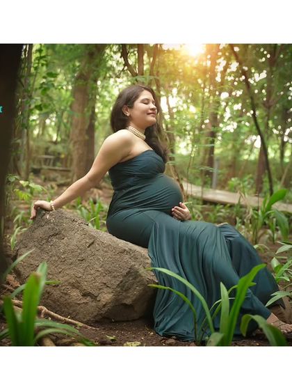 A moment of quiet reflection amidst nature. We found a perfect, sunlit spot for this serene portrait, allowing the mom-to-be to connect with her baby bump in peace.