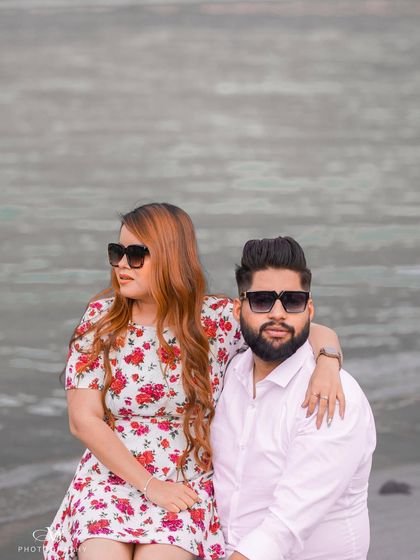 A cool and modern portrait of the couple in sunglasses by the river, perfect for a contemporary pre-wedding album.