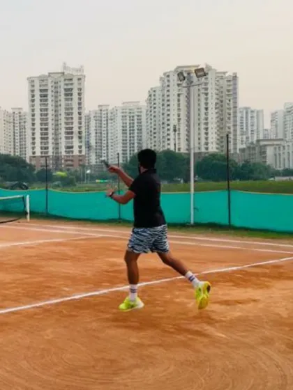 An action shot of a junior player practicing his backhand during a training session. Our programs are designed to develop all aspects of a player's game, from groundstrokes to serves.