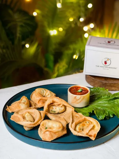 Our crispy fried wontons are filled with a delicious vegetable mix and fried to a perfect golden brown. Served on a platter with a side of spicy dipping sauce, they are an irresistible treat.