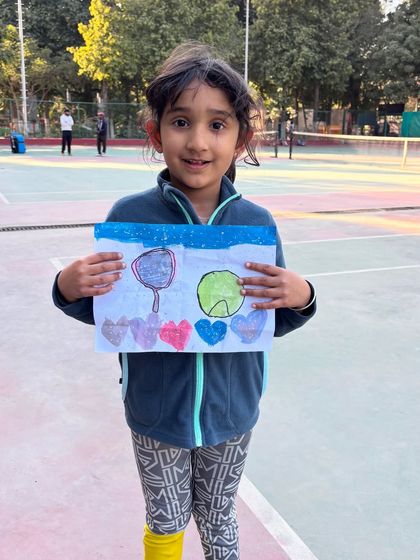 The love for tennis, expressed through art. One of our youngest players showing her drawing of her favorite sport. We love seeing their passion extend beyond the court.
