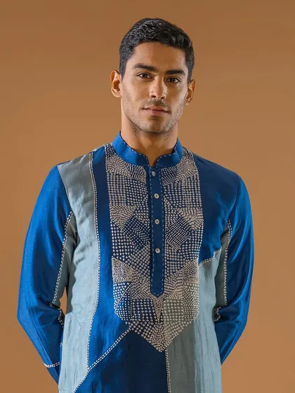This two-toned blue kurta features a patchwork design with intricate embroidery on the chest. It is a proud representation of the vibrant colors and cultures of our nation.