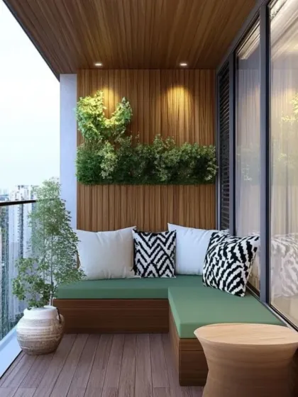 We designed a built-in L-shaped bench with vibrant green cushions to add a pop of color to this balcony. The natural wood flooring and paneled wall are complemented by a small vertical garden, creating a fresh and inviting corner.