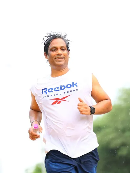 A wet but happy runner. We embrace the challenge, whether it's the heat, humidity, or rain.