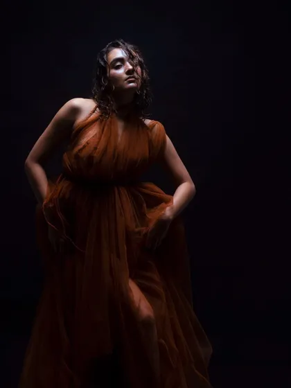 A low-key lighting shot that emphasizes the highlights on the model's skin and wet hair. This demonstrates my ability to create makeup that performs well under different lighting conditions.