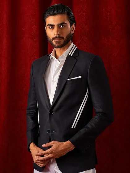 A full portrait of our black blazer with modern white striped accents on the collar and pockets. It's a contemporary twist on a formal classic.