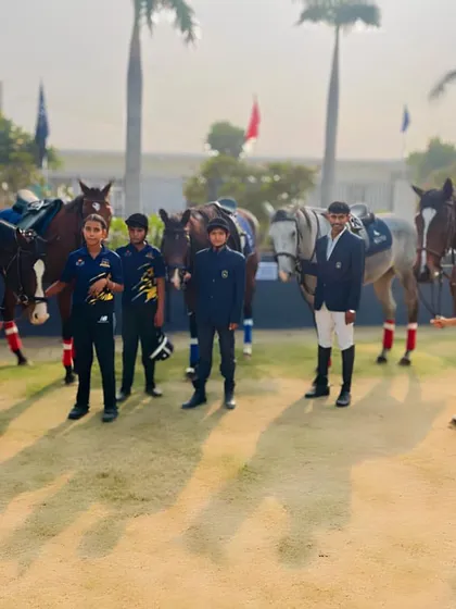 The Uma Equestrian Academy team, composed of riders of different ages, gathers for a group photo, showcasing our inclusive and goal oriented community.