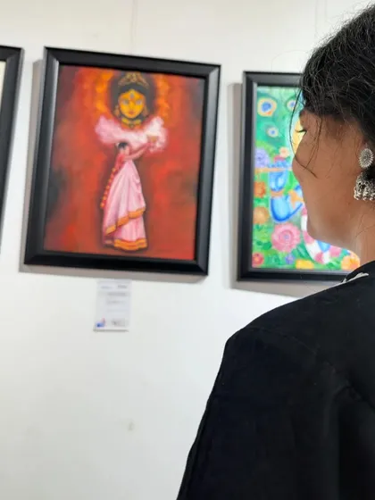 A moment of admiration for a student's work on display. The details and emotion in this piece are a testament to her skill.