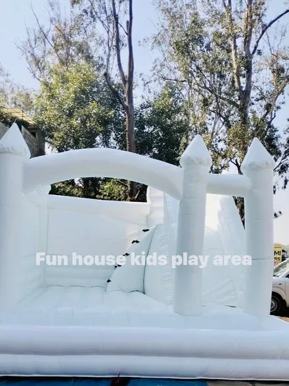 A clear, full shot of our 15x15 foot 4-in-1 white bouncy castle, showcasing its size and features before the party starts.