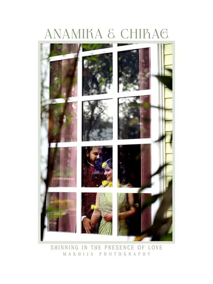 A creative shot from a Haldi ceremony, capturing a quiet moment between the couple through a window frame. It adds an artistic and intimate touch to the vibrant celebration.