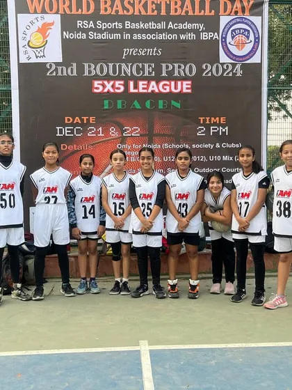 Our U-15 girls' team standing with their coach before a tournament. We have a thriving program for female athletes.