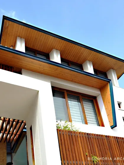 An upward-looking view emphasizing the clean lines of the roof and the warmth of the wood-paneled soffit. This detail showcases our focus on craftsmanship and high-quality natural materials.