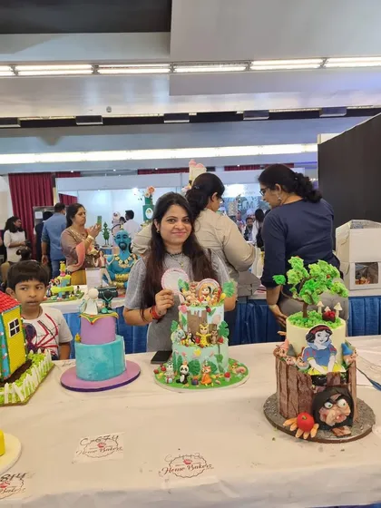 A wider view of the competition display table, showing my cake among other incredible creations.