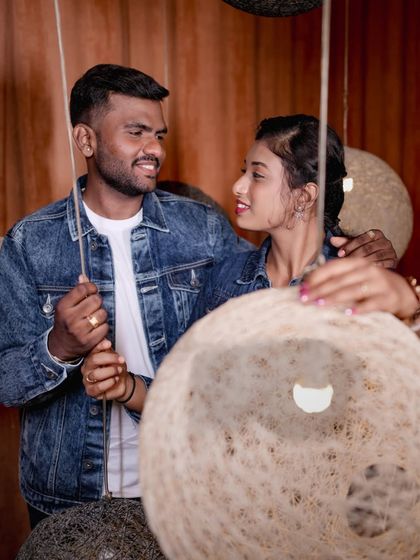 A cozy moment between a couple, framed by the unique texture of our hanging lamps.