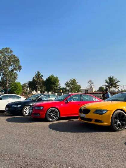 A diverse lineup of sedans parked and on display for fellow enthusiasts to admire.