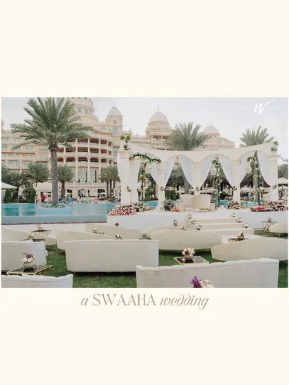 A beautiful poolside mandap setup at a Dubai palace, showcasing an elegant, all-white theme with flowing drapes and comfortable lounge seating for guests.