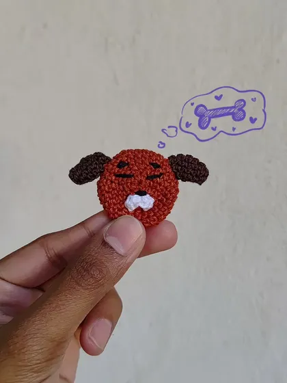 A sleepy puppy pin, dreaming of bones. The doodle adds to the story! This is a flat, applique-style crochet piece, perfect for decorating a jacket or bag.