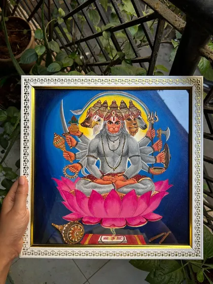 Here is my detailed acrylic painting of Panchamukhi Hanuman, the five-faced form of the deity. I carefully rendered each face and attribute on a 1x1 ft canvas, capturing his divine strength and protective aura. This piece is set in an ornate white frame.