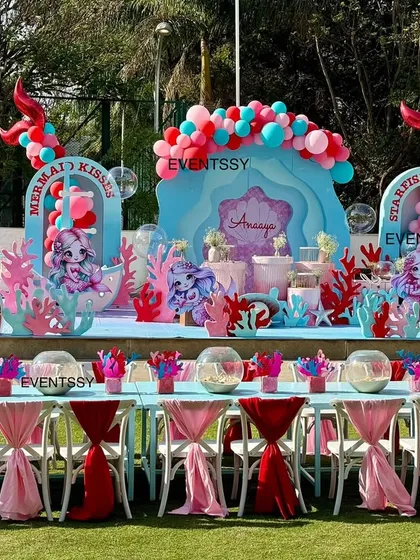 An enchanting 'Under the Sea' party, featuring a large mermaid-themed stage and themed seating for guests.