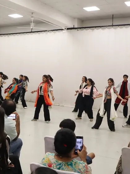 Another angle of our student showcase, capturing the synchronized movement and colorful costumes of the performance. Every student gets their moment to be a star.