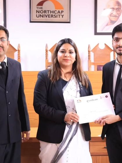 Presenting a certificate to a participant in the moot court competition. Recognizing the hard work and talent of these students is one of the most rewarding parts of being a judge.