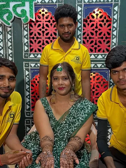Our team with a happy bride at her mehndi ceremony. We offer free home service across Mumbai for your convenience.