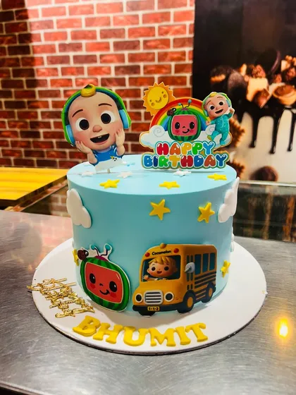 A single-tier Cocomelon cake for Bhumit, featuring JJ, the iconic school bus, and a watermelon, all made with bright, kid-friendly colors.