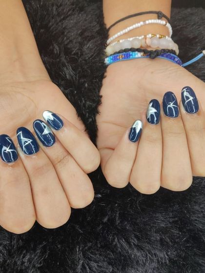 A cool and abstract design in deep blue and white. The hand-painted white starbursts create a striking contrast against the dark, shimmery blue base.