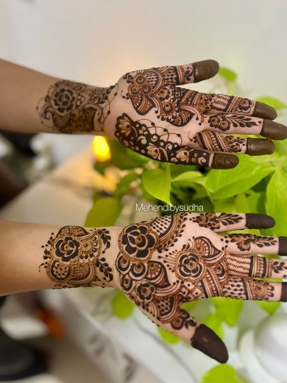 A creative pose showing the bold floral work of this Indo-Arabic design.