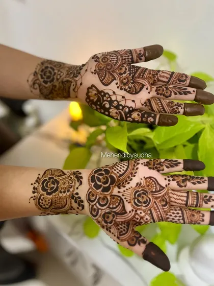 A creative pose showing the bold floral work of this Indo-Arabic design.