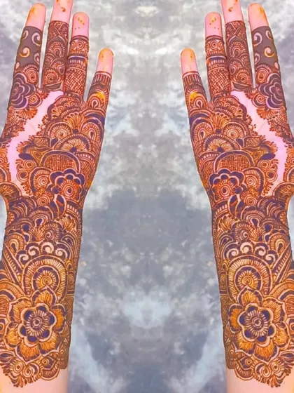 A stunning full-coverage design with a central floral pattern that flows into intricate details up the arm. The negative space in the middle creates a beautiful 'bail' effect within a heavy design.