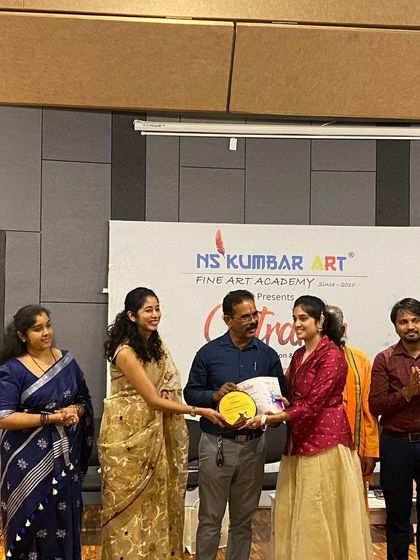 The joy of recognition. A student is presented with her award, a culmination of her hard work and creative journey with us.