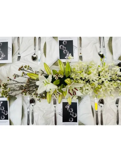 A beautiful centerpiece of white lilies and orchids from the plum and grape themed dinner.