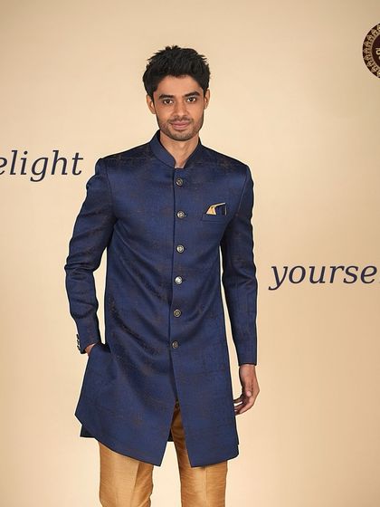Delight yourself with this deep blue Indo-Western jacket paired with golden trousers, a rich and royal combination.