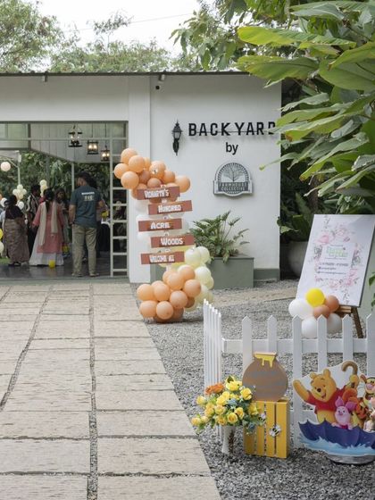 The entrance to this Winnie the Pooh party at the Farmhouse Collective. I used a simple balloon garland and themed props to blend with the venue's rustic charm.