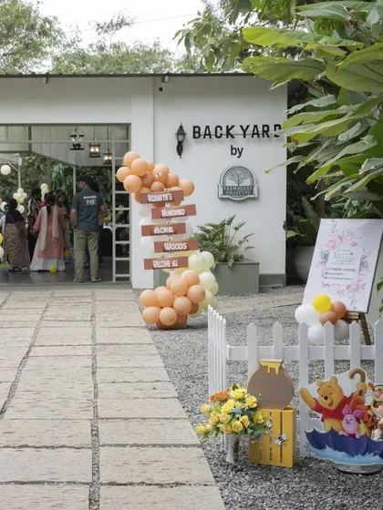 The entrance to this Winnie the Pooh party at the Farmhouse Collective. I used a simple balloon garland and themed props to blend with the venue's rustic charm.