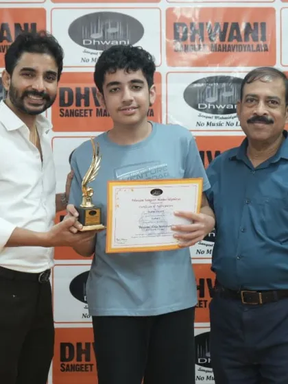 A teacher and our director present an award to a student.