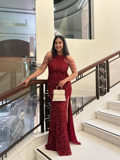 A full-length view of my red cocktail gown. The thigh-high slit adds a touch of modern glamour, while the structured fit ensures a polished and sophisticated look.