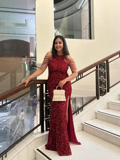 A full-length view of my red cocktail gown. The thigh-high slit adds a touch of modern glamour, while the structured fit ensures a polished and sophisticated look.