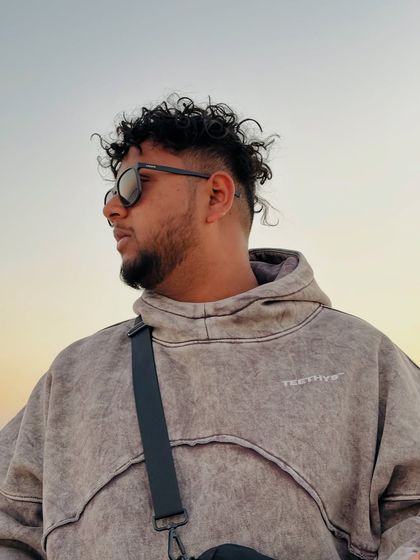 A close-up shot from the "Lambo" video shoot. The look, the glasses, the vibe. It's all part of the Spectra persona.